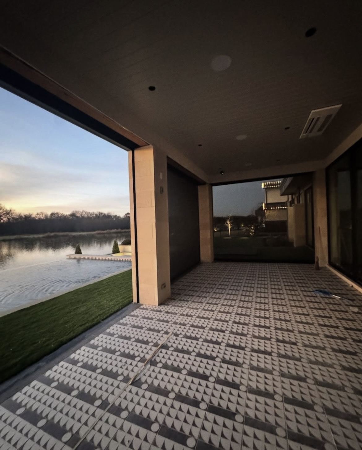 View out from a covered outdoor room through motorized screens