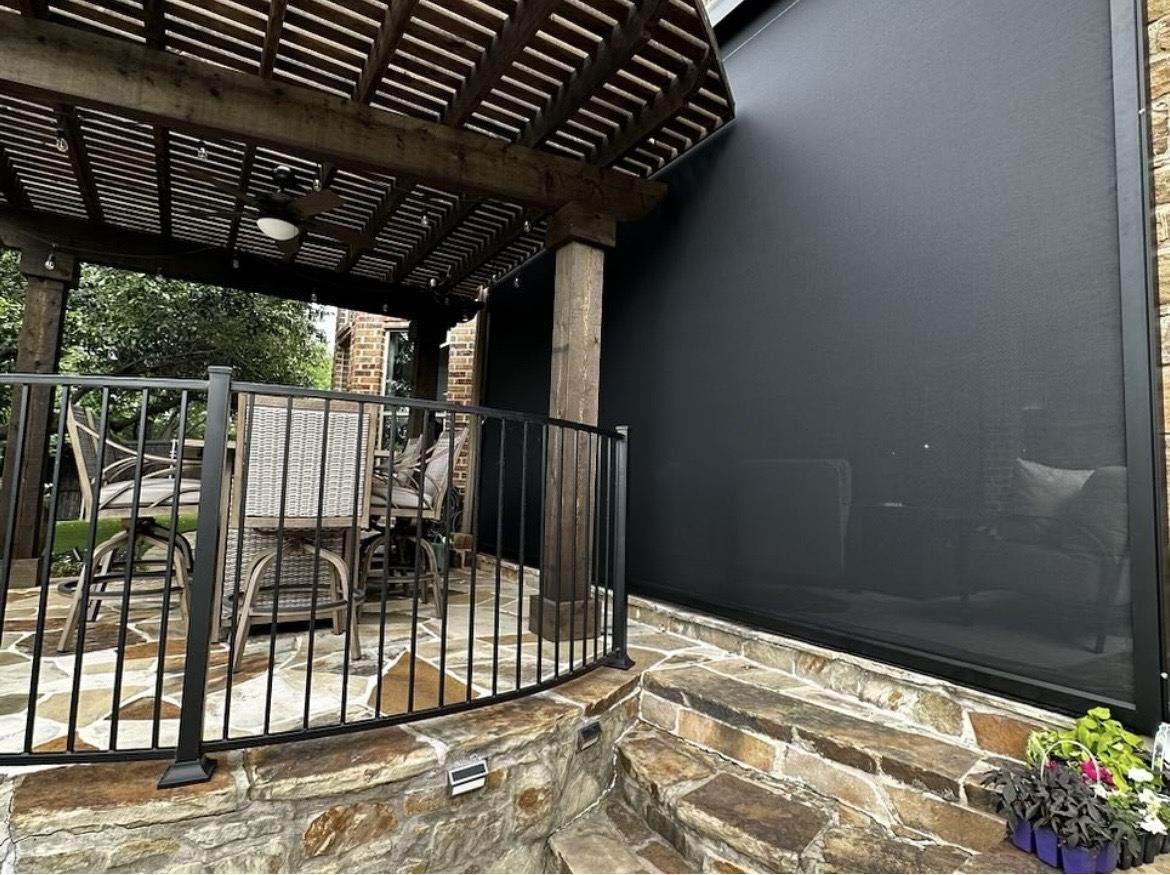 Pergola and motorized screens enclosing a backyard patio